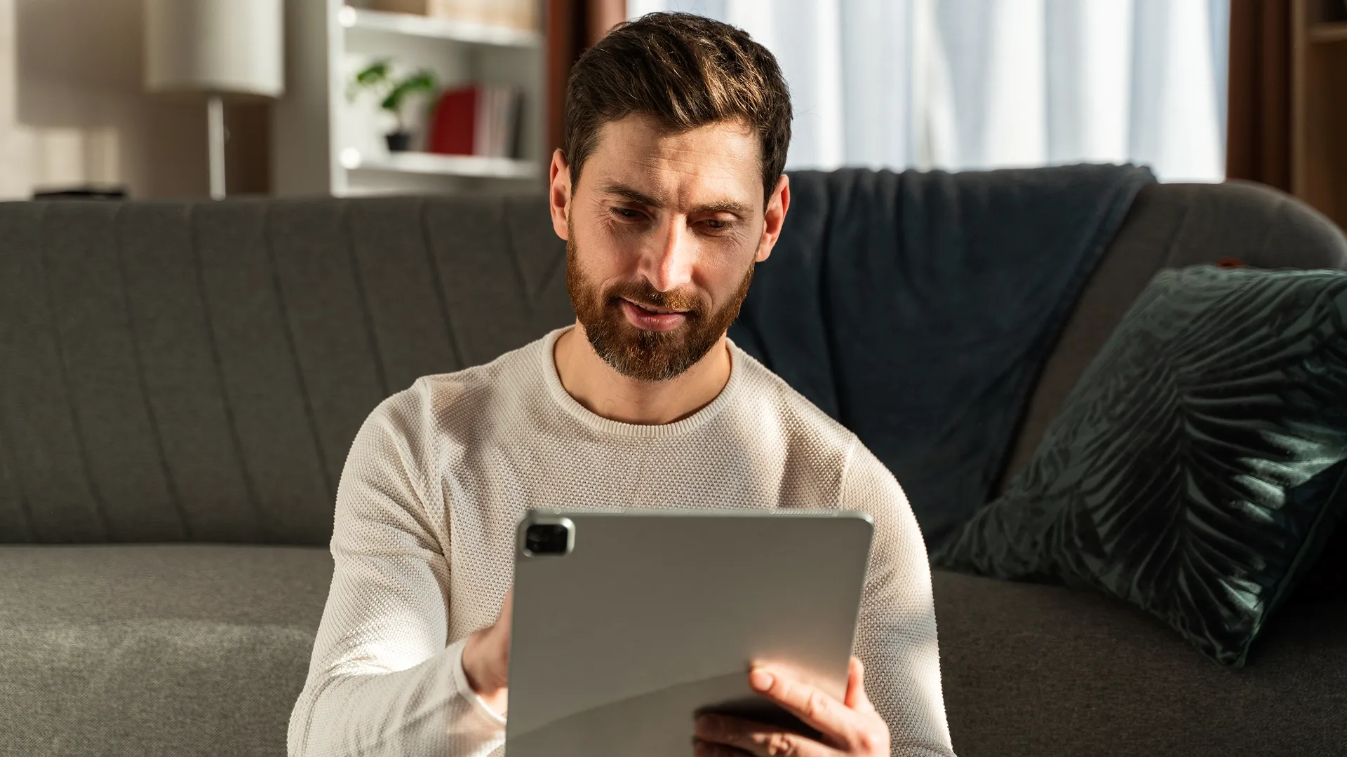 photo of a man shopping for a car online using a tablet