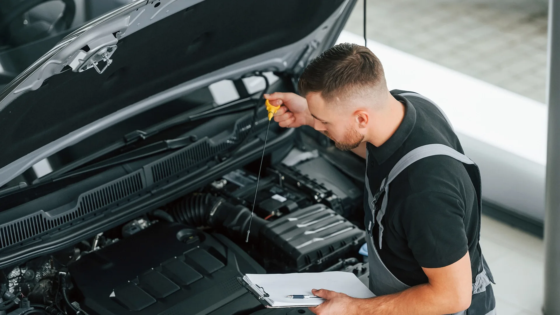 photo of a mechanic inspecting a used car before purchase