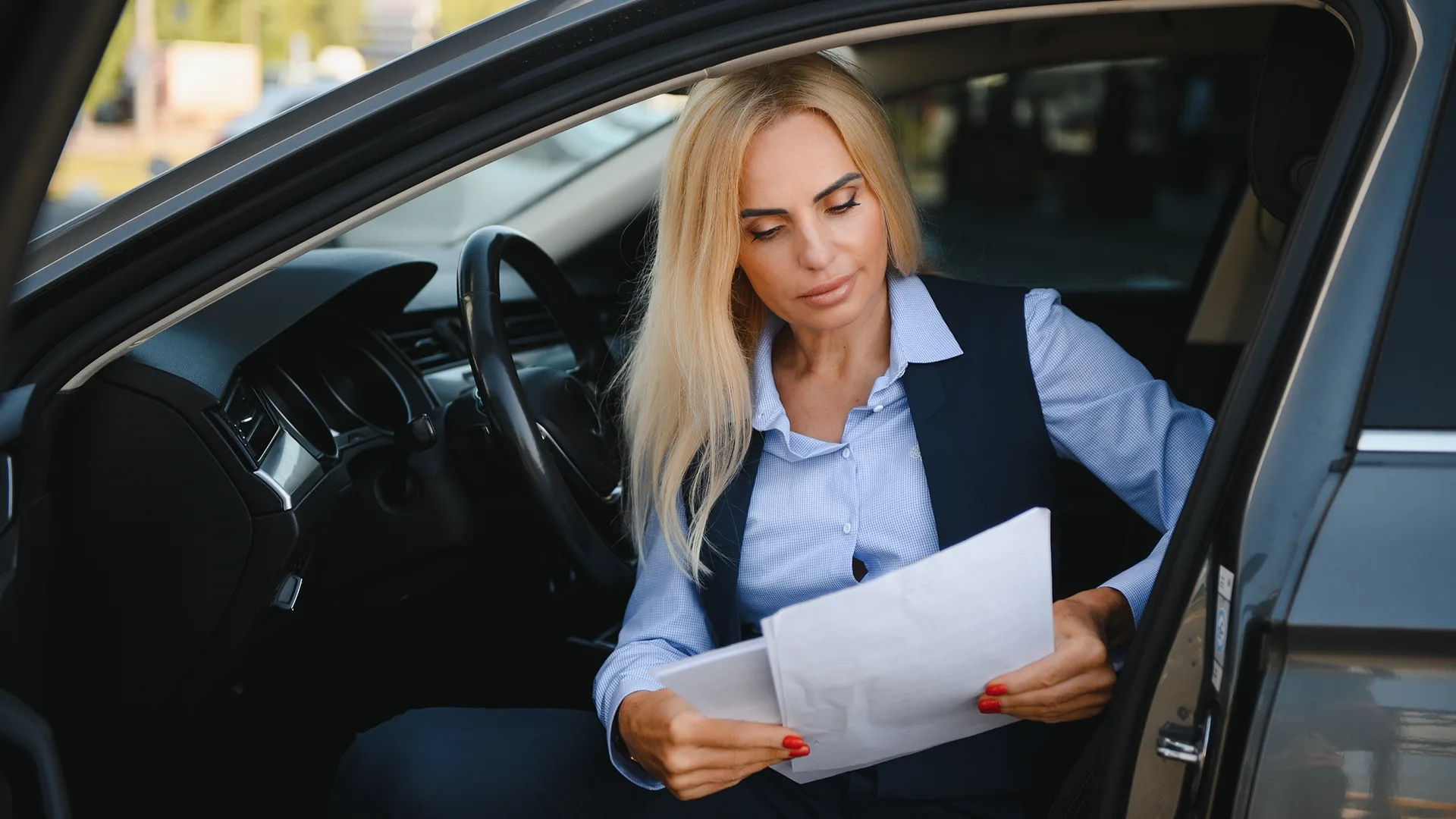 Buyer reviewing vehicle documents before purchasing a car out of state photo