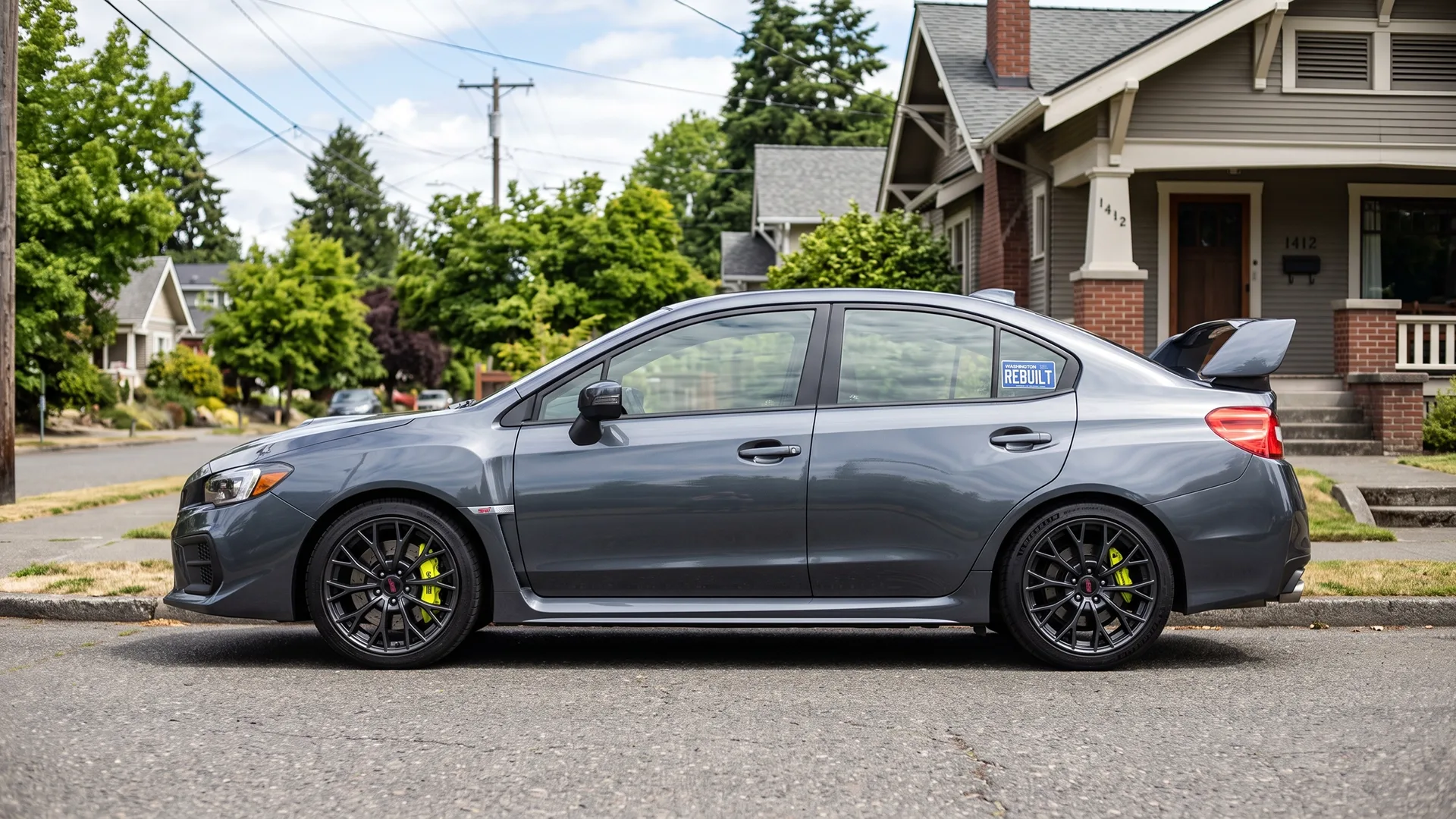 Gray sedan with a rebuilt title parked on a residential street
