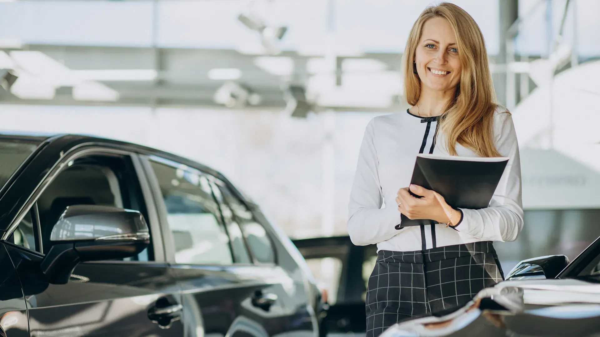 A car dealership consultant helps assess the value of cars.
