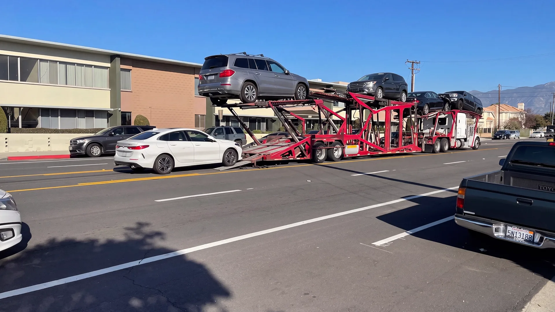 A car being loaded onto an auto transport carrier for delivery to an out-of-state buyer