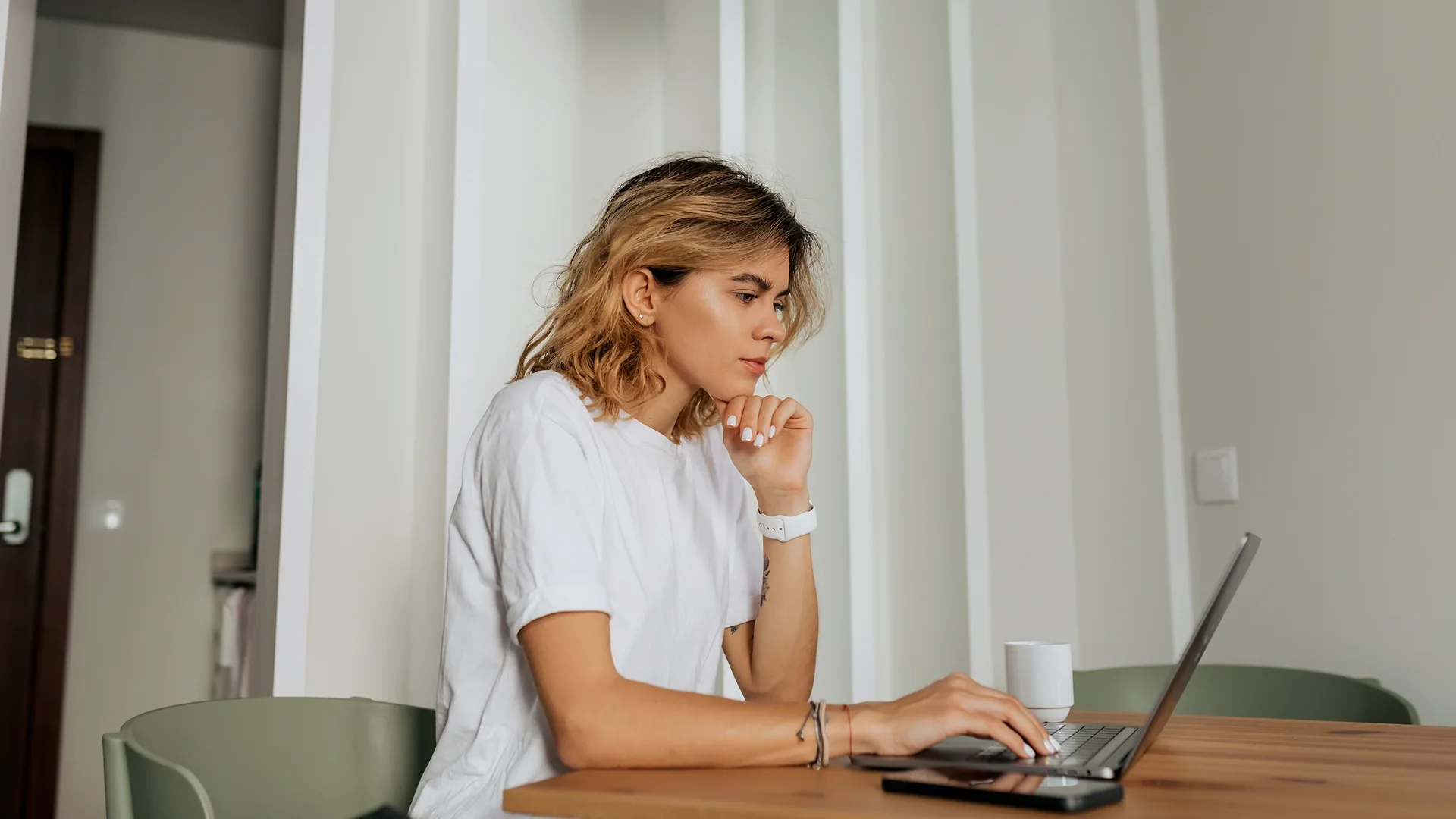 A woman is choosing a car buying service.