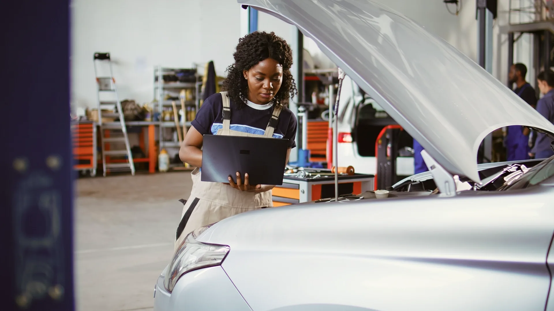 photo of a mechanic inspecting a car before sale