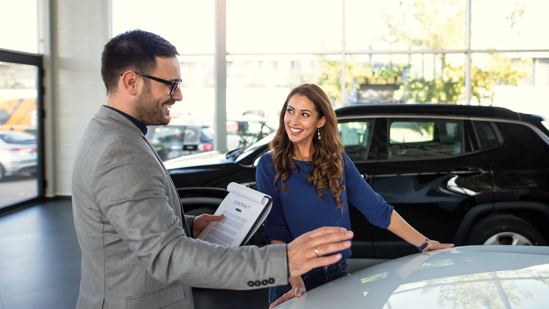The consultant helps a person buy a car from a trusted dealership.
