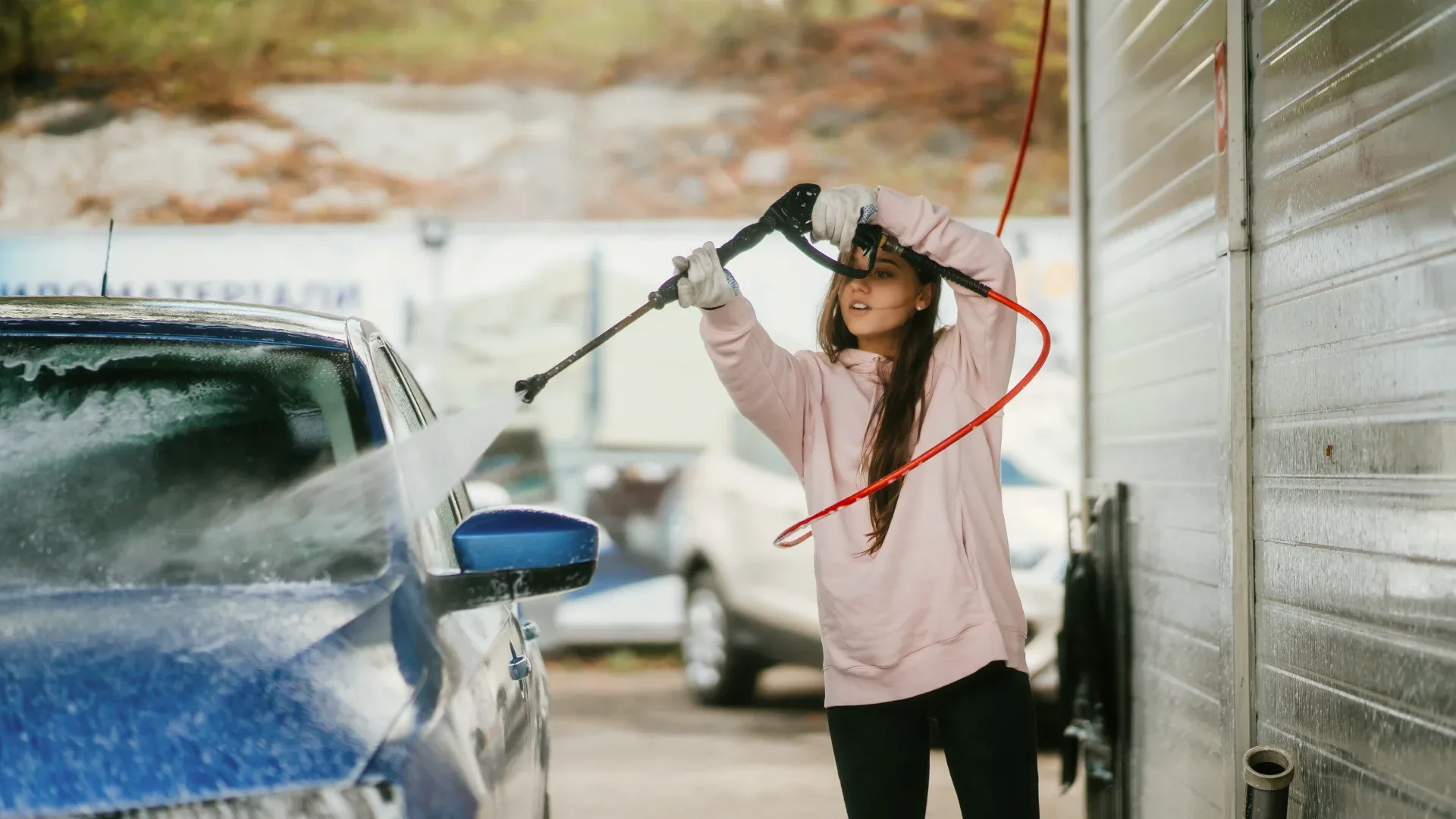 The woman is cleaning his car
