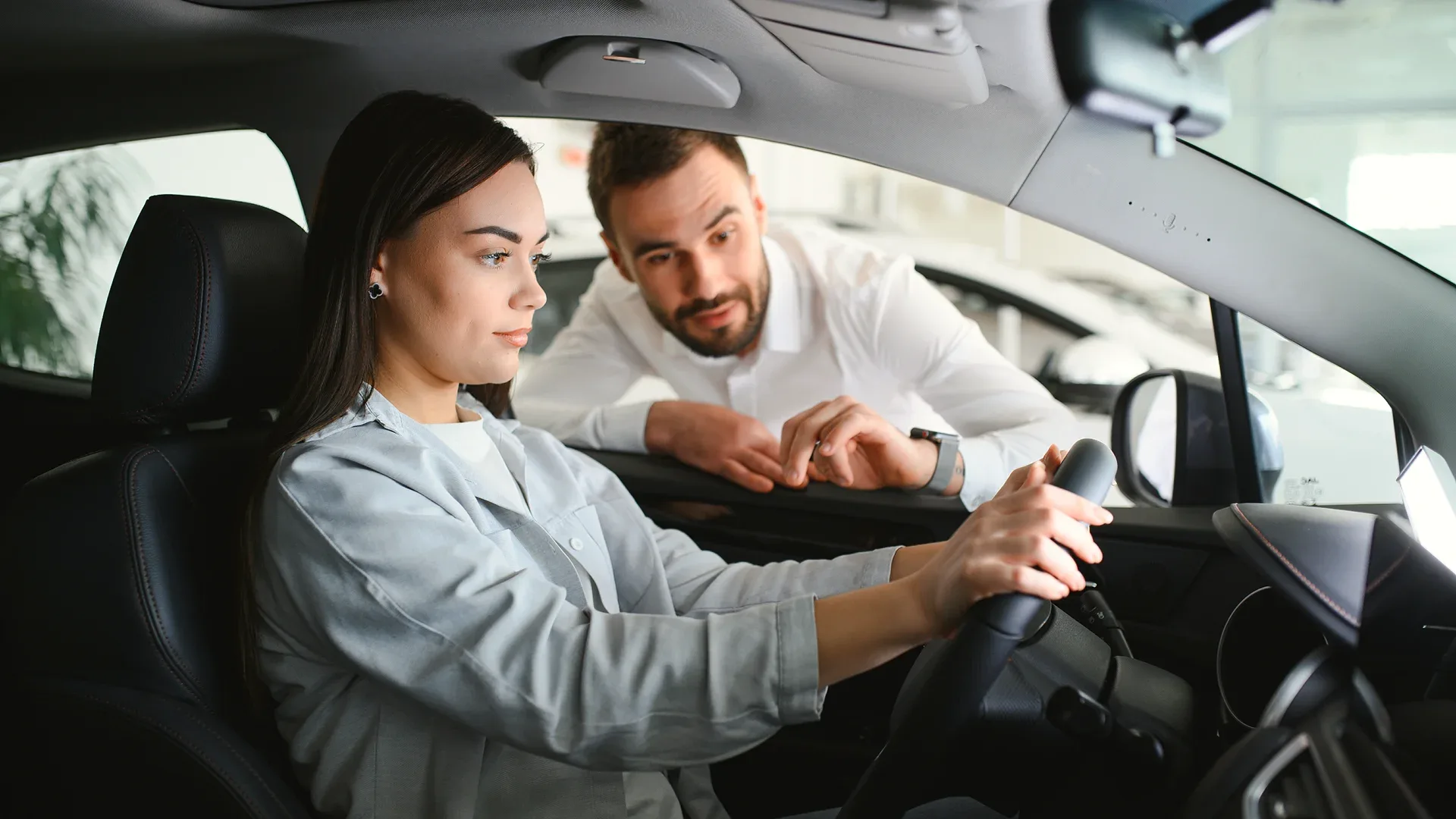 The woman doesn't realize where she is, and the man is trying to conduct a test drive.