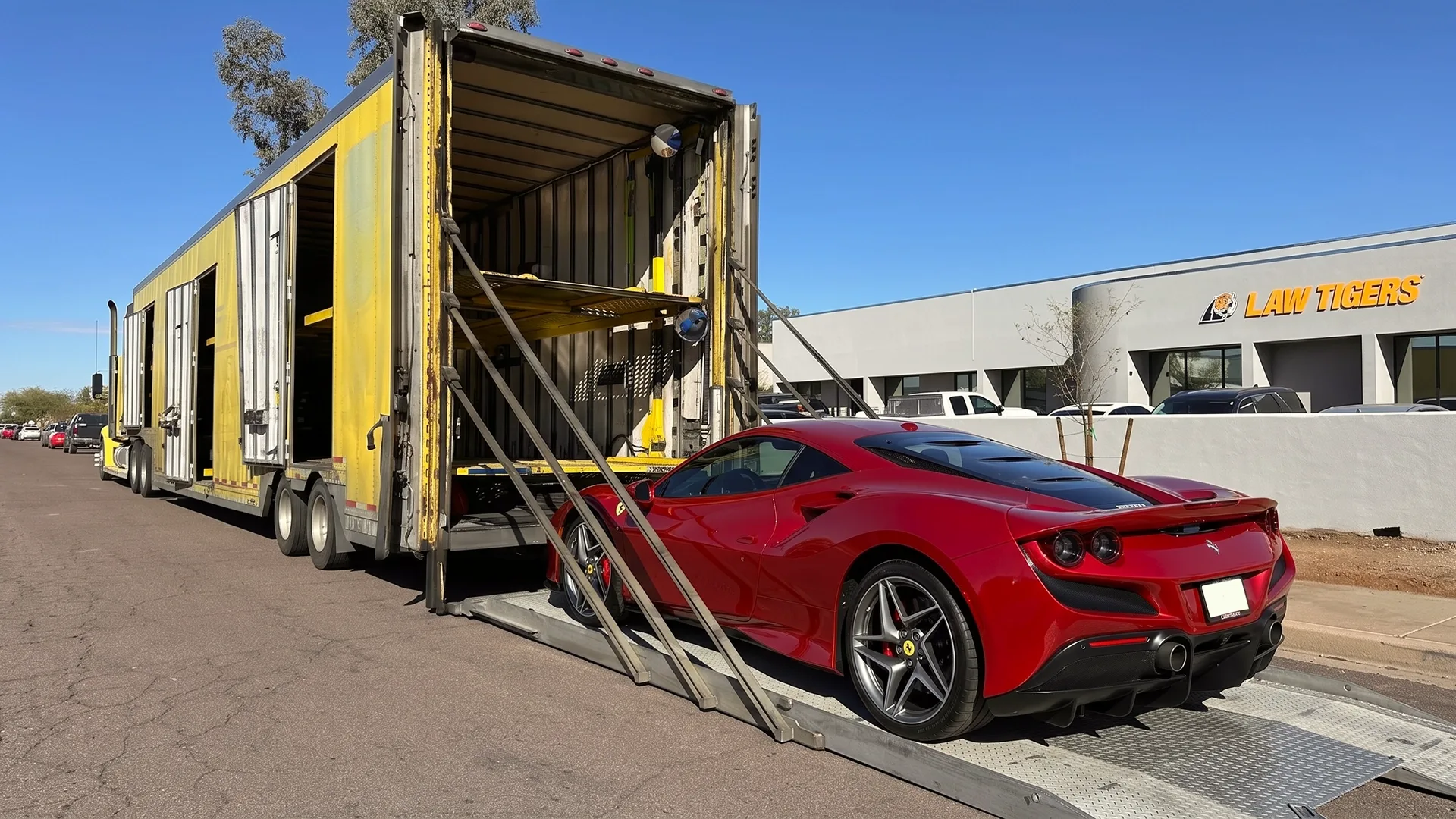 Luxury car loading into enclosed auto transport trailer with liftgate