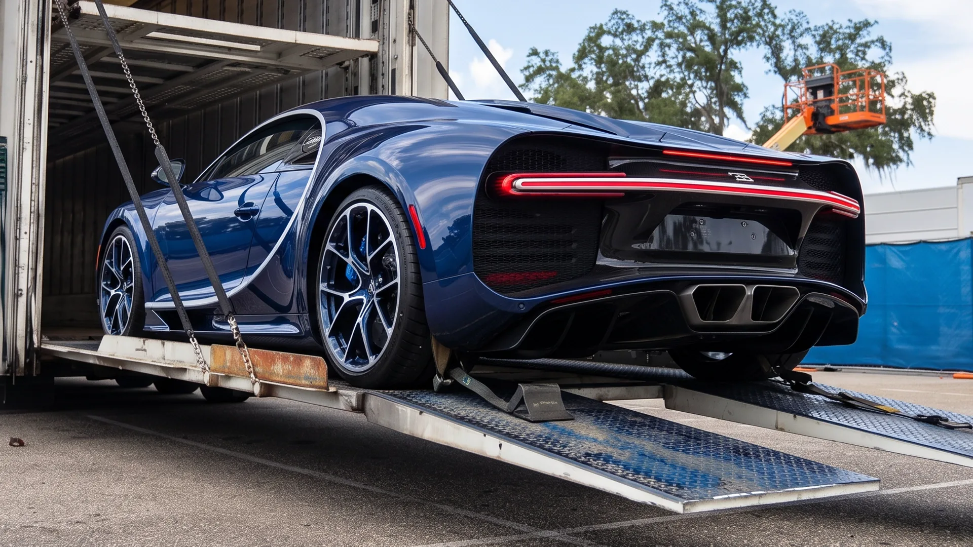 Luxury sports car secured inside enclosed auto transport trailer