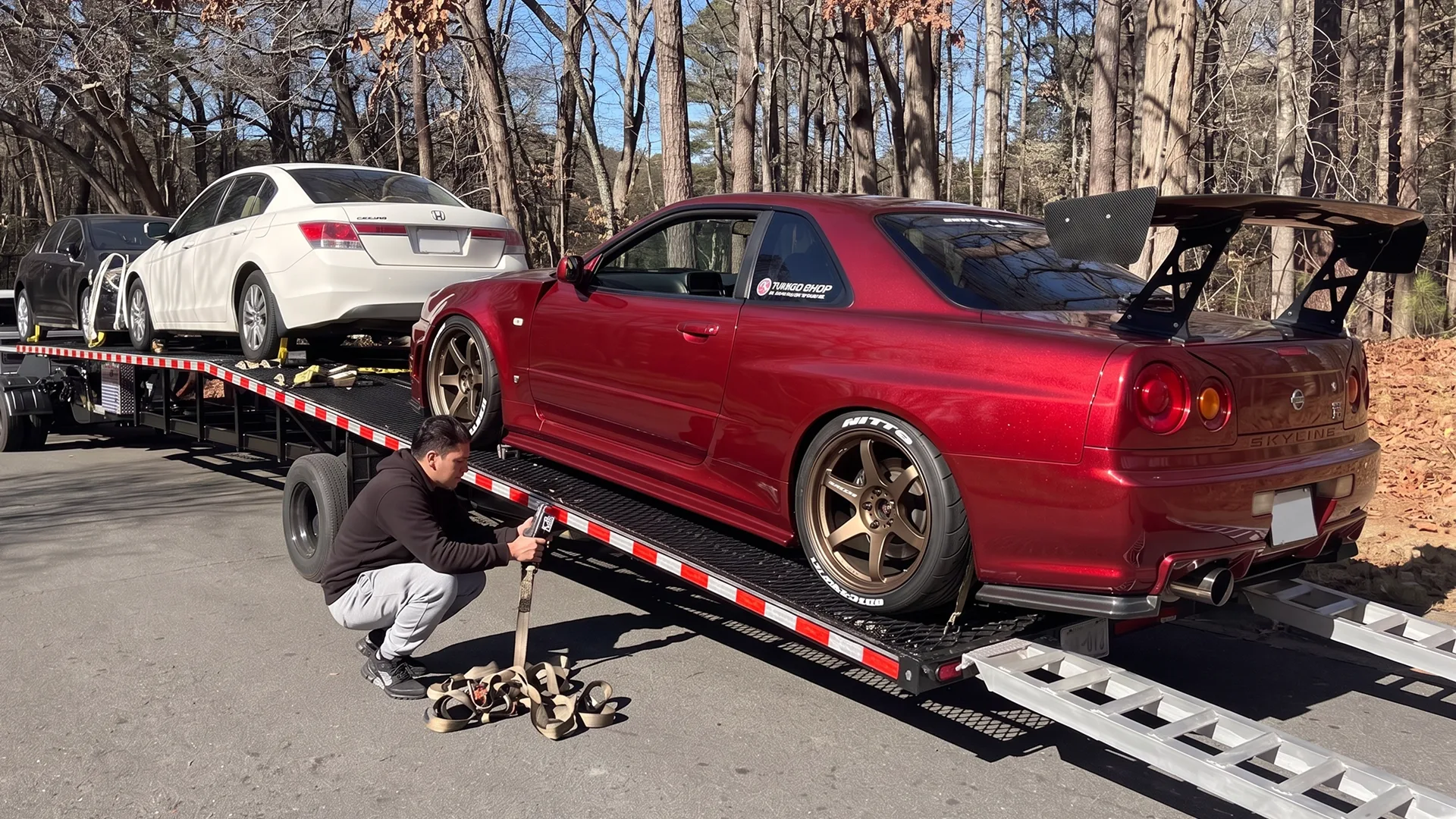 Modified car transported on an open auto carrier