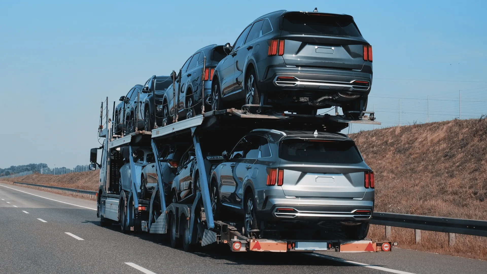 Cars transported on an open auto carrier during a cross-country move