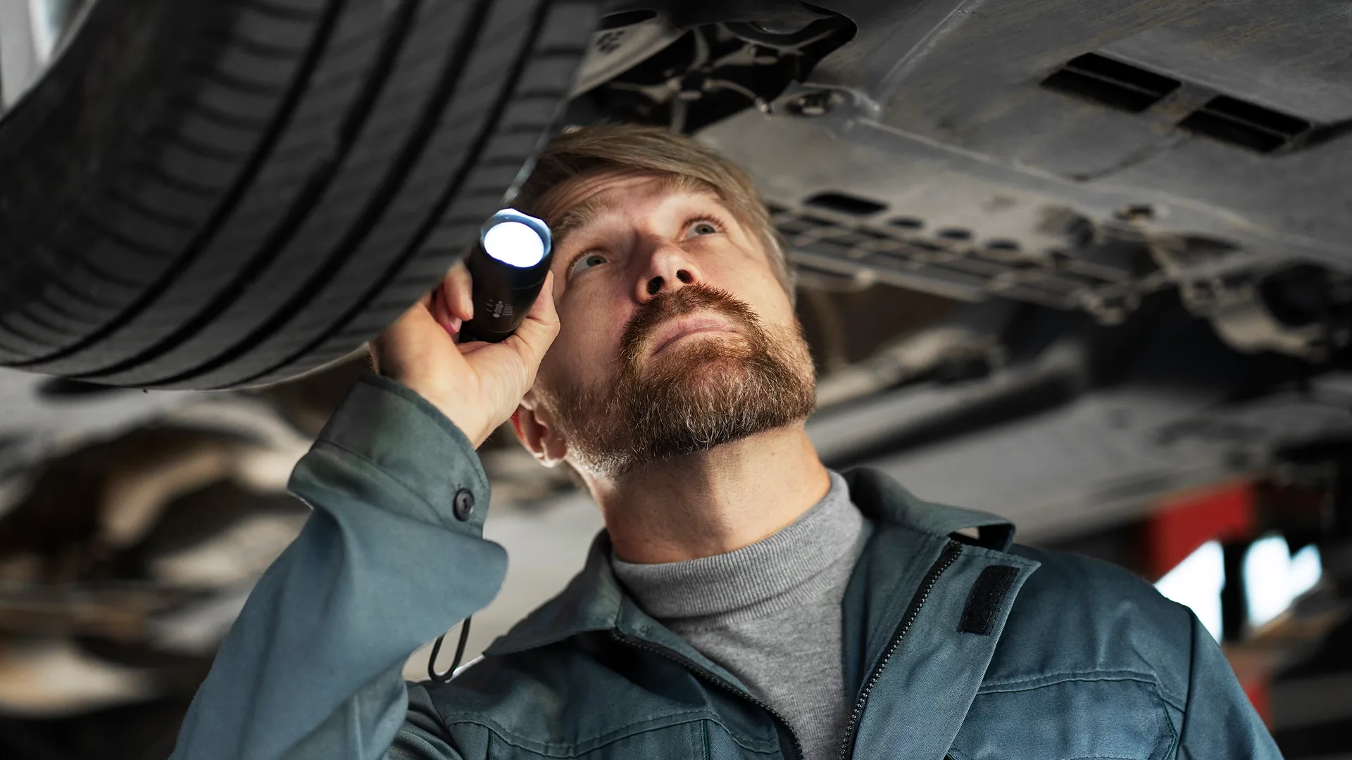 Mechanic inspecting a used car before purchase