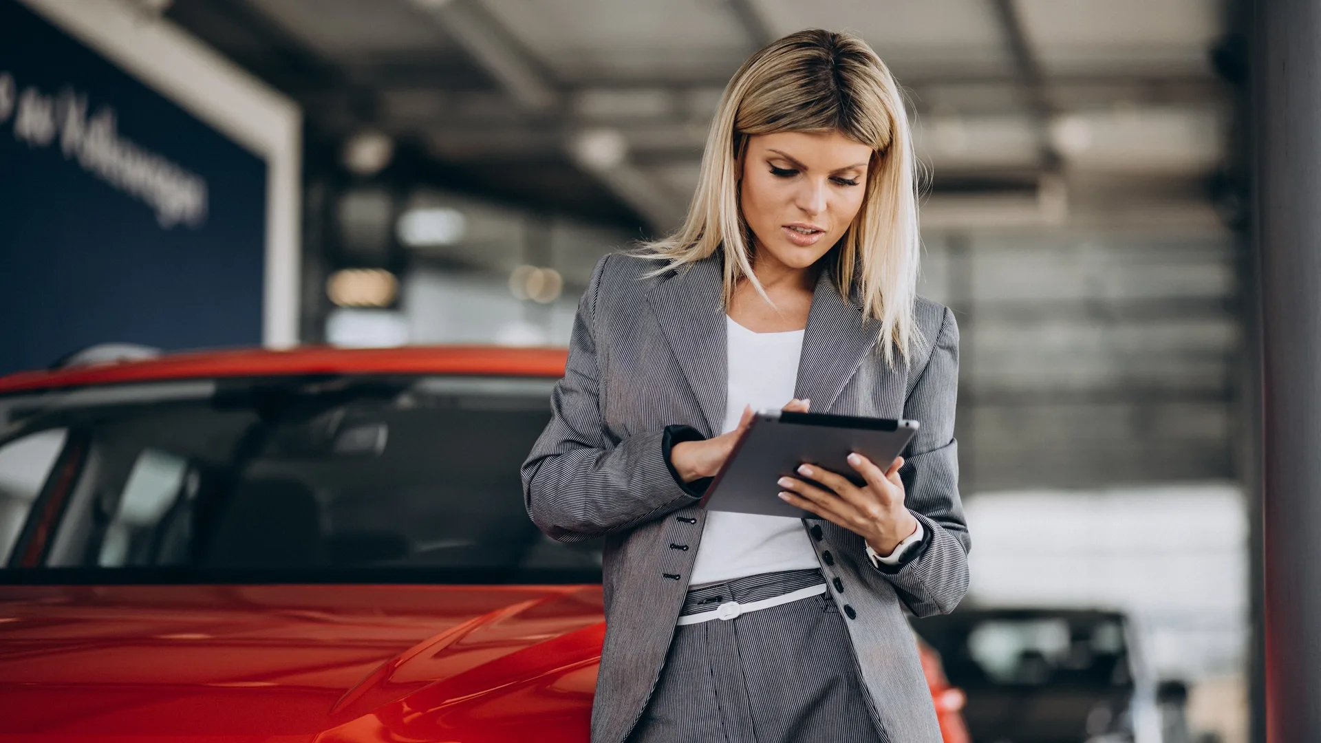 A woman assesses the value of a car.