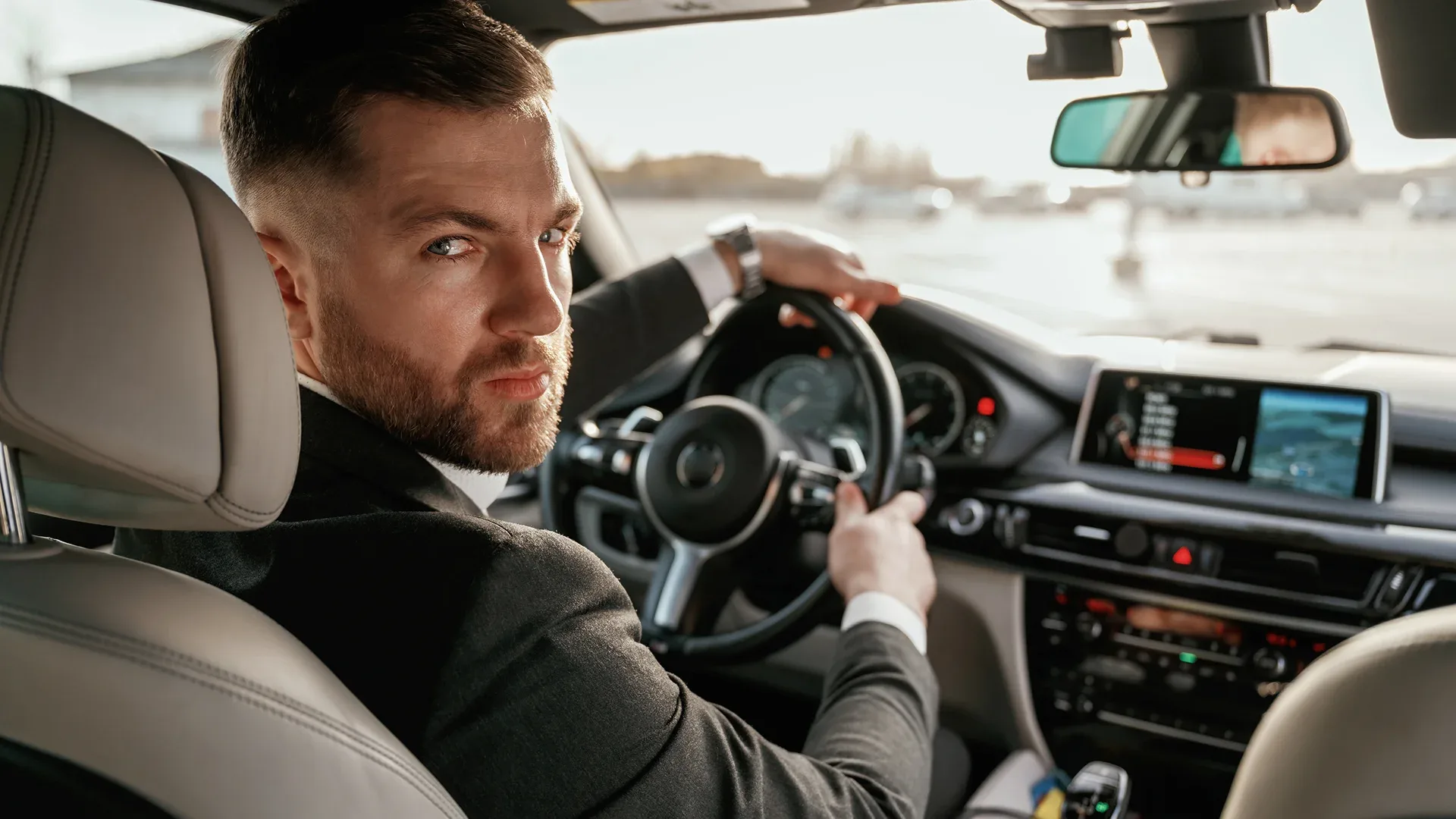 A man is recording how many miles his car has driven