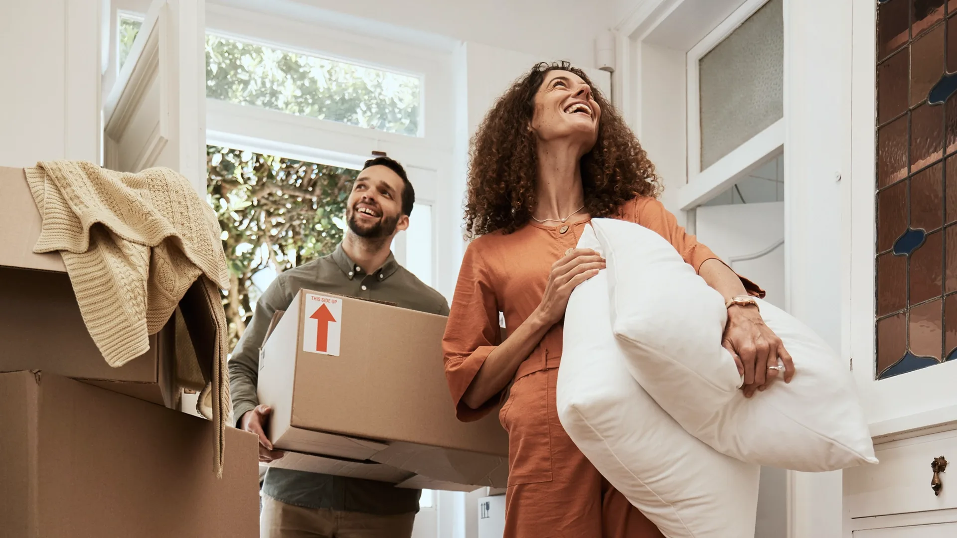Couple unpacking boxes after moving into a new home