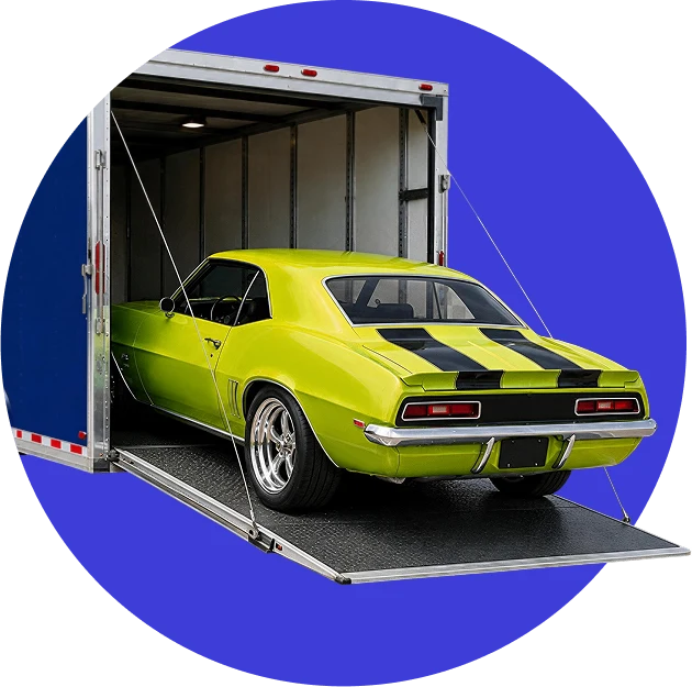 Classic muscle car secured inside an enclosed car carrier