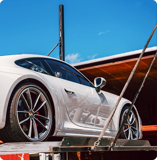 Sports car secured inside an enclosed carrier