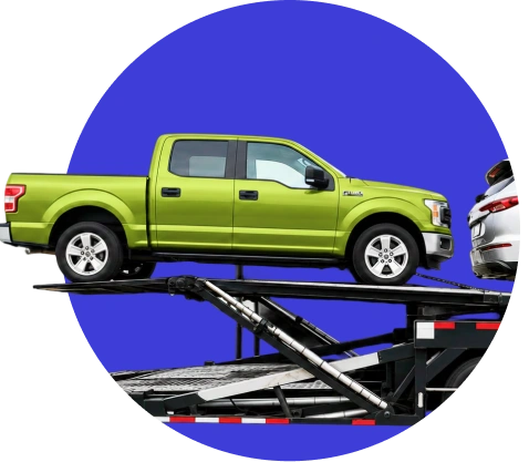 Pickup truck being loaded onto an open car carrier