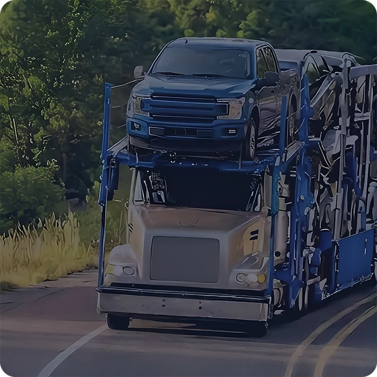 Open car carrier hauling vehicles down a highway